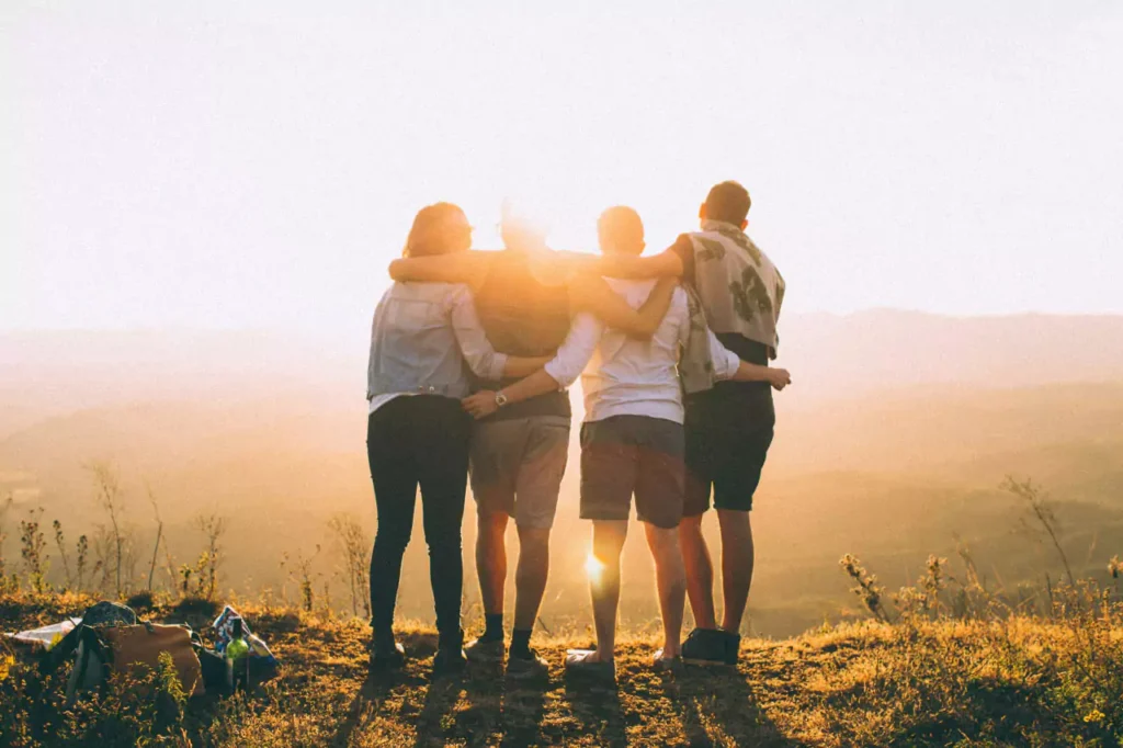 A group of people facing the sun