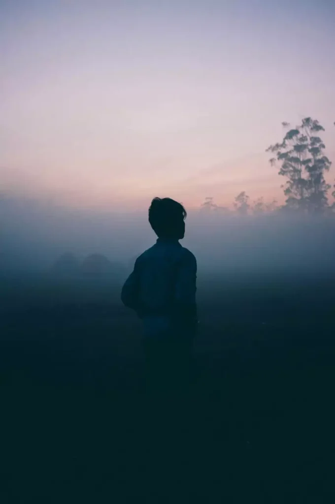 a sad person in the mist