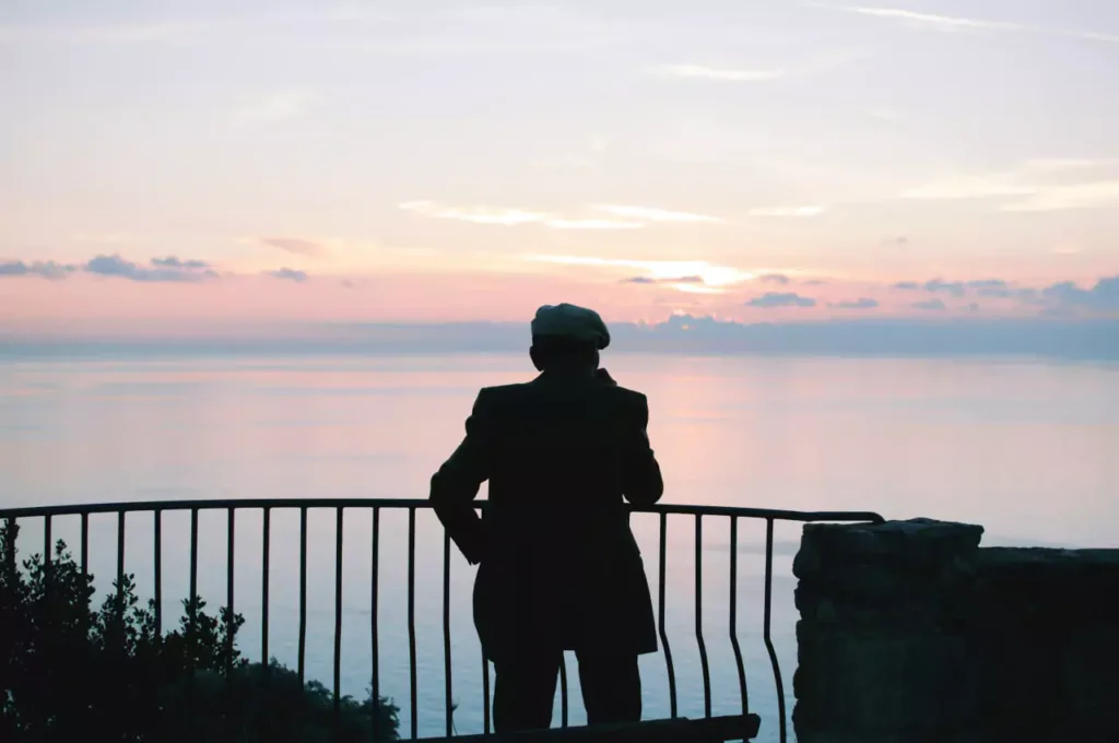 old man alone at sunset reflecting on life lessons