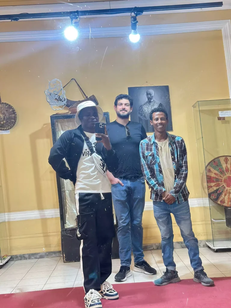 Lucky, Yohun the tour guide, and Arada the brazilian taking a mirror selfie in front of Haile Selassie wife's mirror