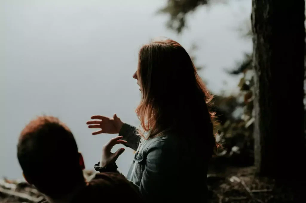 A woman talking to man