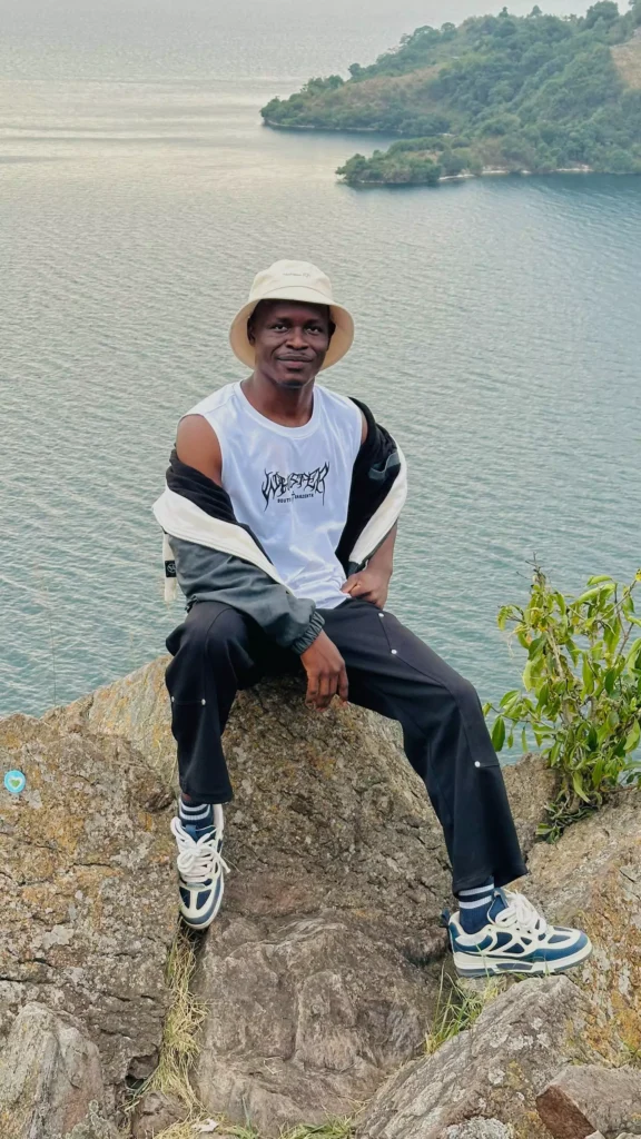 Jokondo Lucky posing on top of a mountain in Lake Kivu