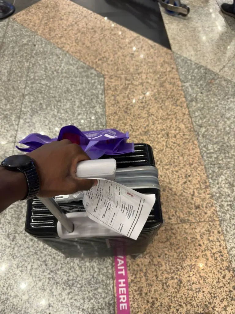 Lucky holding his bag in Kuala Lumpur airport