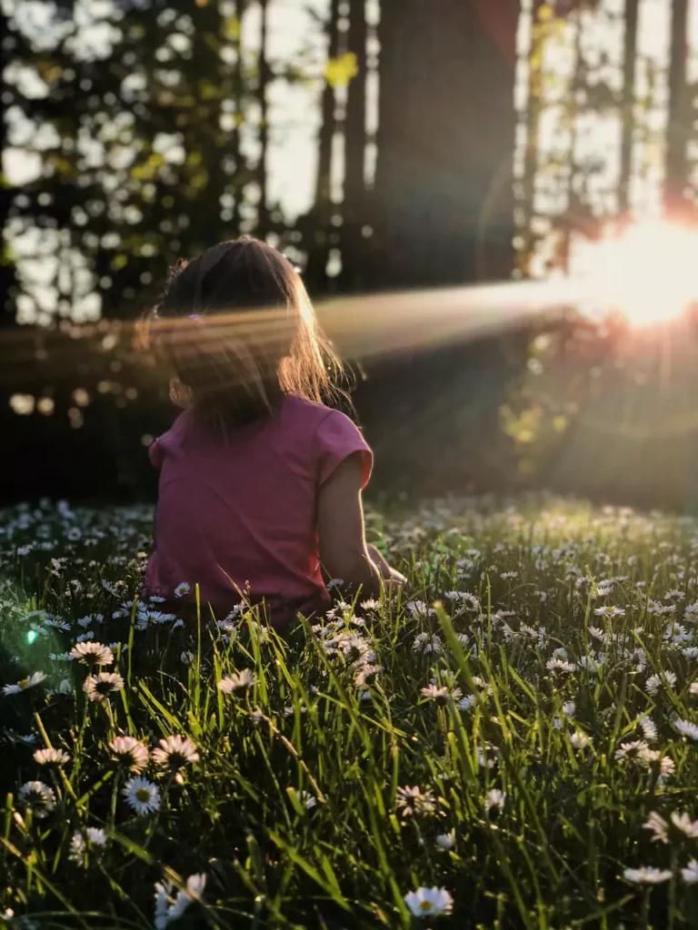 child looking at sun rays
