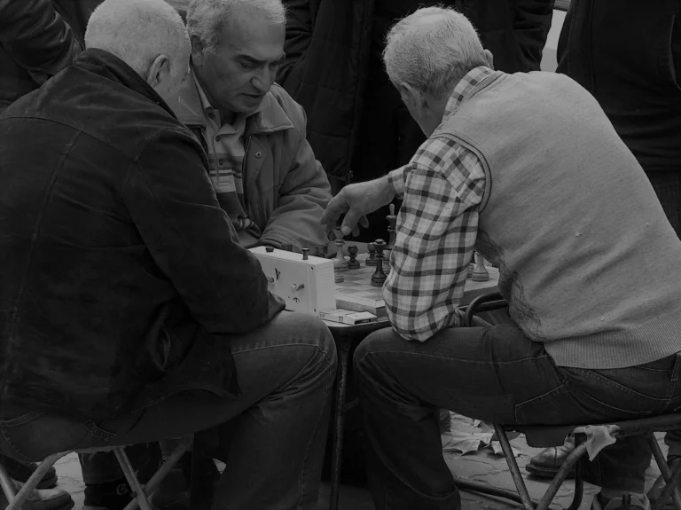 matured people playing chess