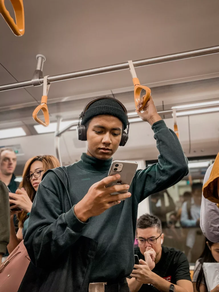a person addicted to his phone in a train