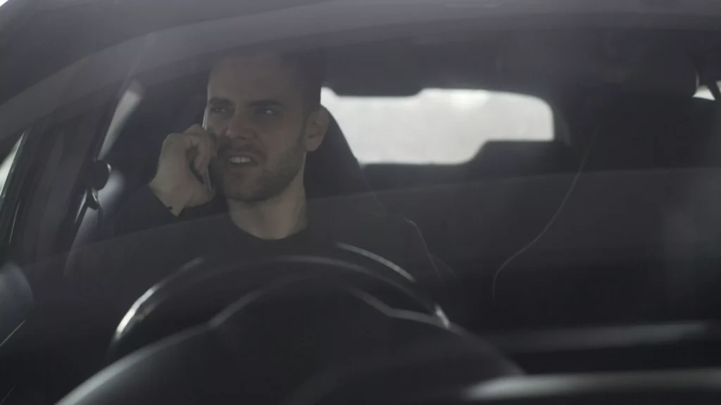 A person on phone angry in a car