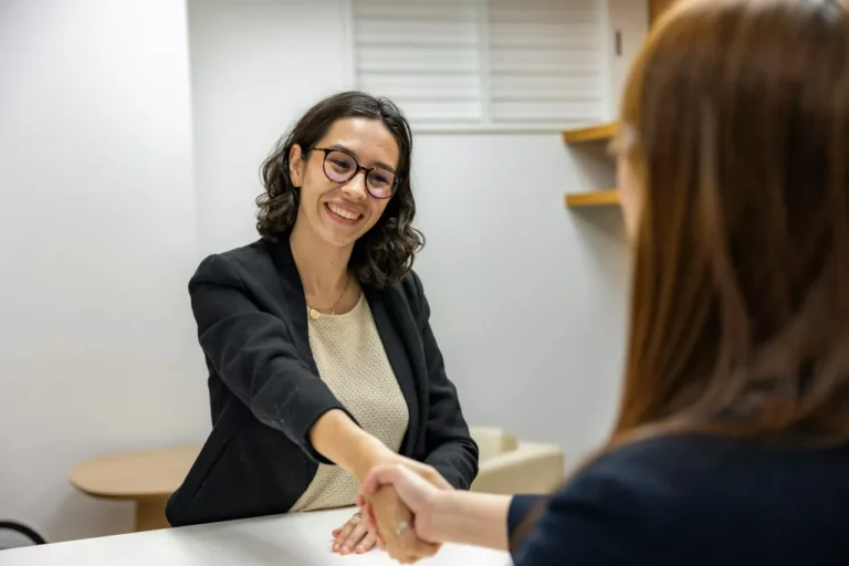 Two women shaking hands