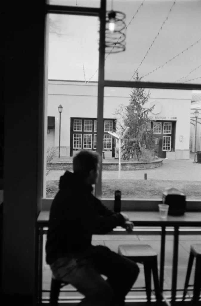 a man with coffee in black and white