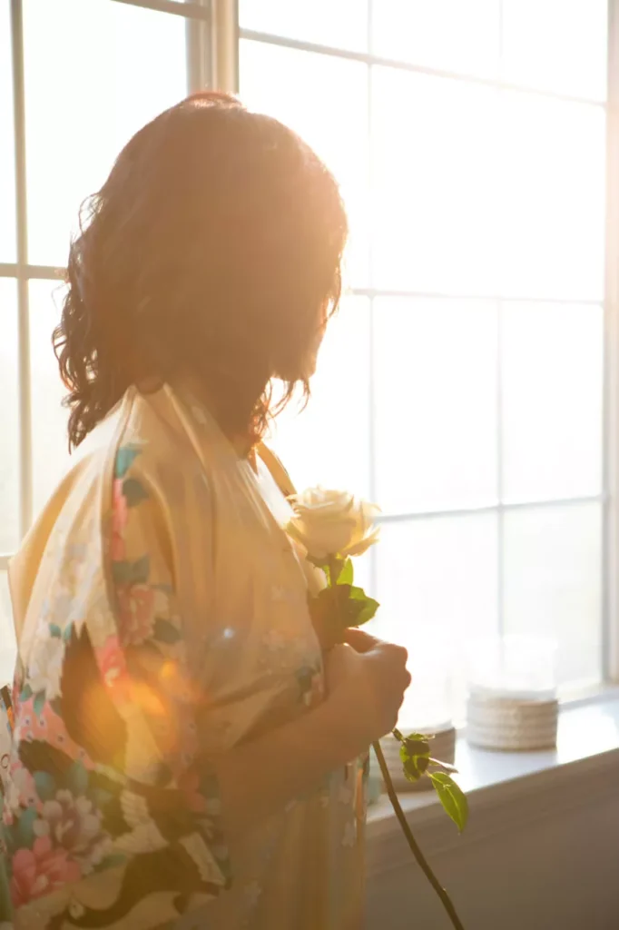woman holding a flower